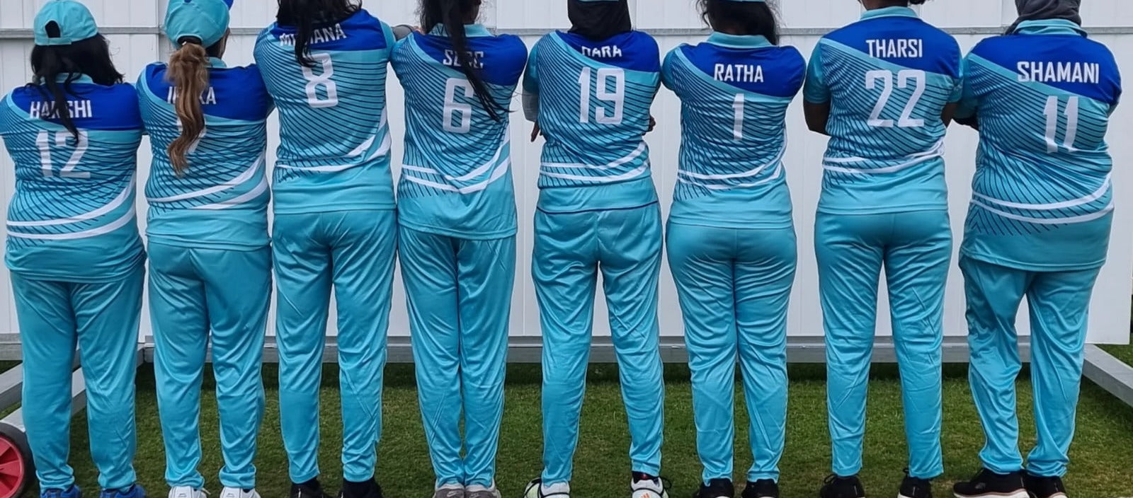 Players together in turquoise team kits